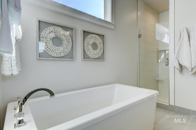 12039 N 19th Ave, Boise, ID 83714 - full bathroom with a freestanding tub, a stall shower, and tile patterned flooring
