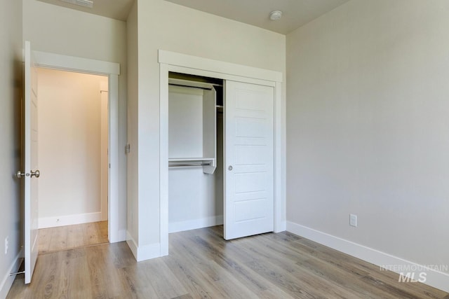 12039 N 19th Ave, Boise, ID 83714 - unfurnished bedroom with wood finished floors and a closet