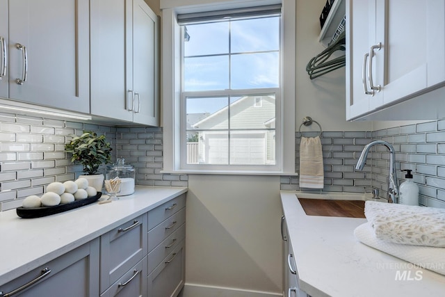 12039 N 19th Ave, Boise, ID 83714 - kitchen featuring light countertops, decorative backsplash, and gray cabinets