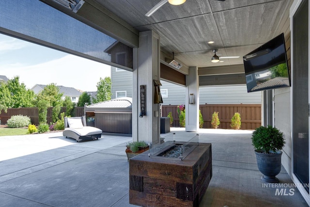 12039 N 19th Ave, Boise, ID 83714 - fenced backyard featuring a ceiling fan, a patio, an outdoor fire pit, and a hot tub
