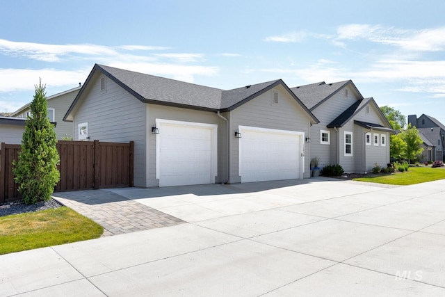 12039 N 19th Ave, Boise, ID 83714 - view of front of home with a garage, driveway, and roof with shingles