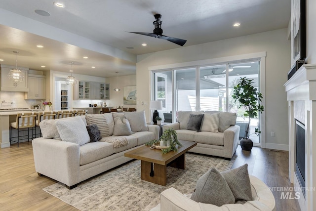 12039 N 19th Ave, Boise, ID 83714 - living room with a ceiling fan, recessed lighting, light wood-type flooring, and a high end fireplace