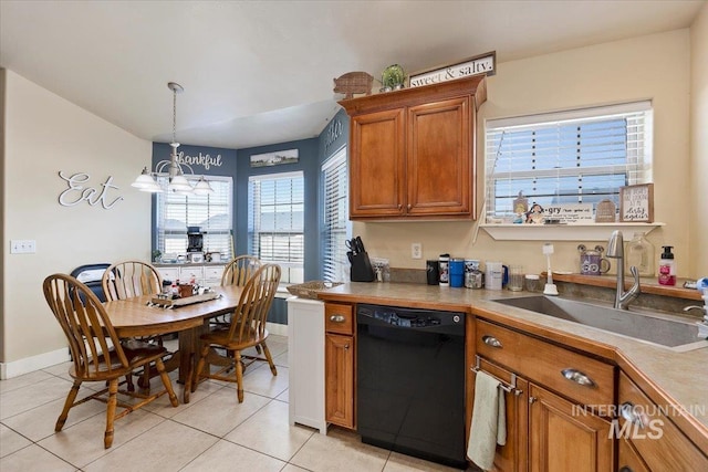 kitchen with light tile patterned floors, black dishwasher, brown cabinets, decorative light fixtures, and an inviting chandelier