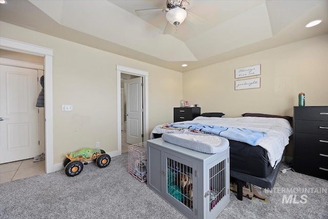 bedroom with carpet floors, a tray ceiling, baseboards, and recessed lighting