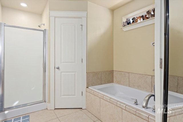 bathroom featuring a garden tub, a shower stall, visible vents, and tile patterned flooring