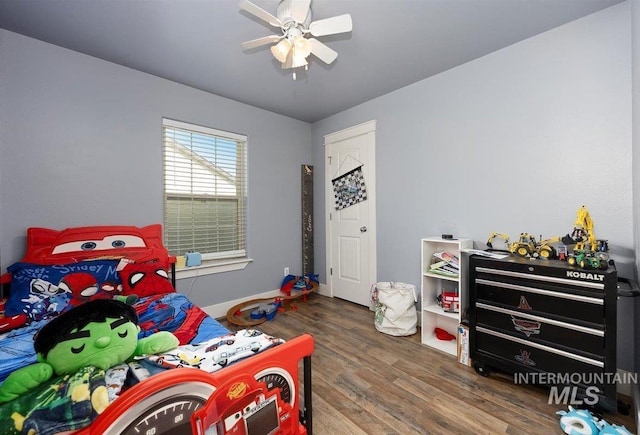 bedroom with baseboards, a ceiling fan, and wood finished floors