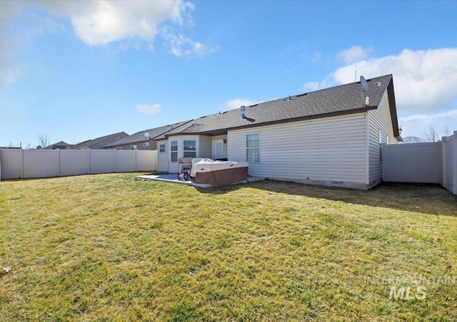 rear view of house with crawl space, a fenced backyard, and a lawn