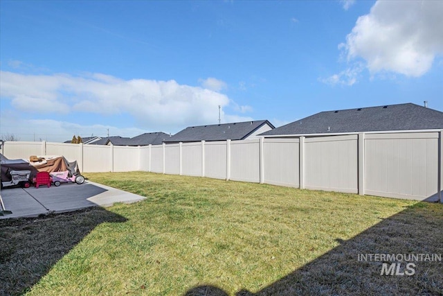 view of yard featuring a patio area and a fenced backyard