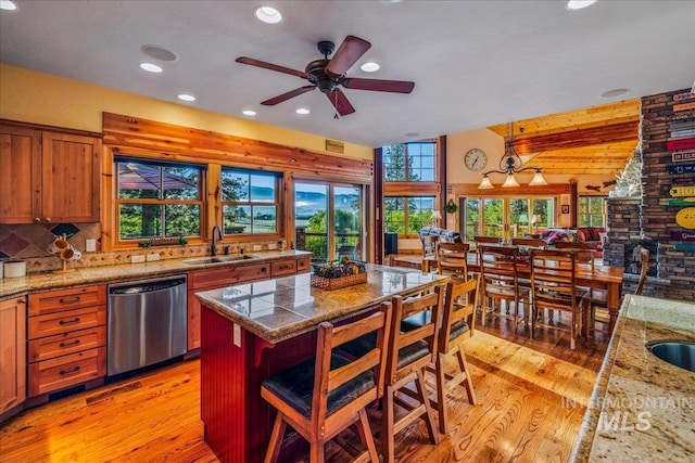 3872 Brookside Dr, New Meadows, ID 83654 - kitchen featuring dishwasher, a sink, light wood-style flooring, recessed lighting, and a kitchen bar