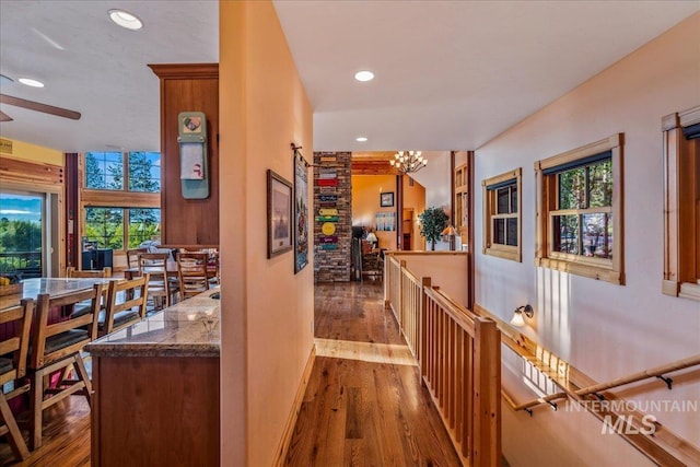 3872 Brookside Dr, New Meadows, ID 83654 - corridor with dark wood-style floors, plenty of natural light, a chandelier, recessed lighting, and an upstairs landing