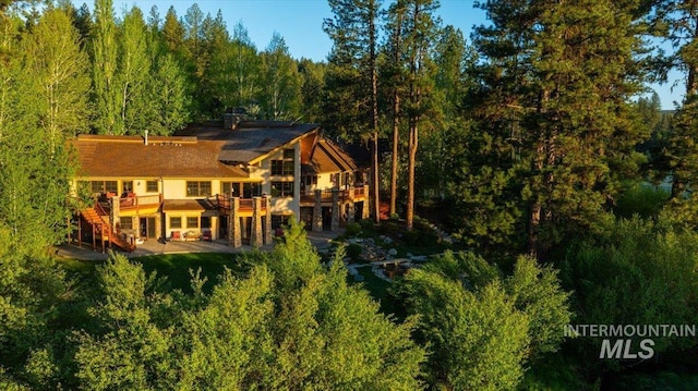 3872 Brookside Dr, New Meadows, ID 83654 - back of house featuring stairway, a forest view, and a wooden deck