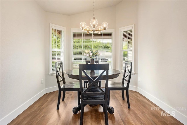 4112 W Cherrytree Ct, Meridian, ID 83642 - dining space with a chandelier, baseboards, wood finished floors, and lofted ceiling