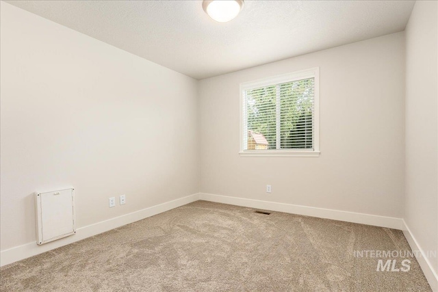 4112 W Cherrytree Ct, Meridian, ID 83642 - carpeted empty room featuring baseboards and a textured ceiling