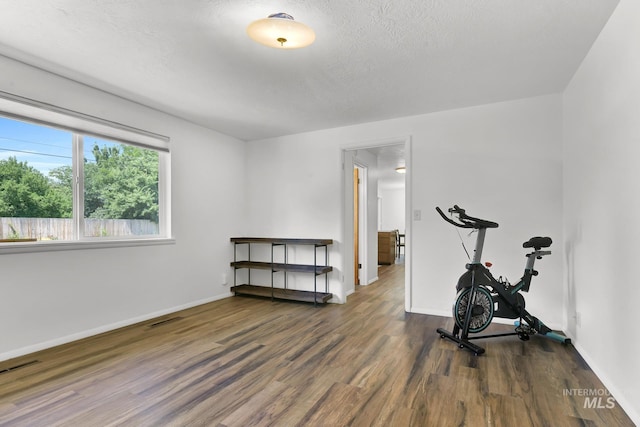 3308 Iowa Ave, Caldwell, ID 83605 - exercise area featuring wood finished floors, attic access, and a textured ceiling