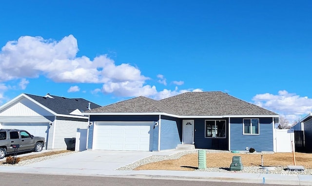 single story home with a garage, concrete driveway, and a shingled roof