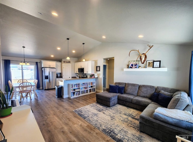 living room with lofted ceiling, baseboards, recessed lighting, and wood finished floors