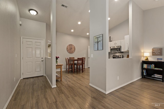 3422 Vistapark Dr, Caldwell, ID 83605 - entrance foyer featuring dark wood-style floors, baseboards, high vaulted ceiling, and recessed lighting