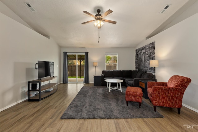 3422 Vistapark Dr, Caldwell, ID 83605 - living area featuring vaulted ceiling, a ceiling fan, wood finished floors, and baseboards