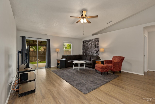 3422 Vistapark Dr, Caldwell, ID 83605 - living area featuring baseboards, a ceiling fan, wood finished floors, and lofted ceiling