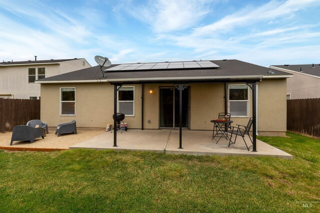 3422 Vistapark Dr, Caldwell, ID 83605 - back of property featuring solar panels, stucco siding, and a patio area