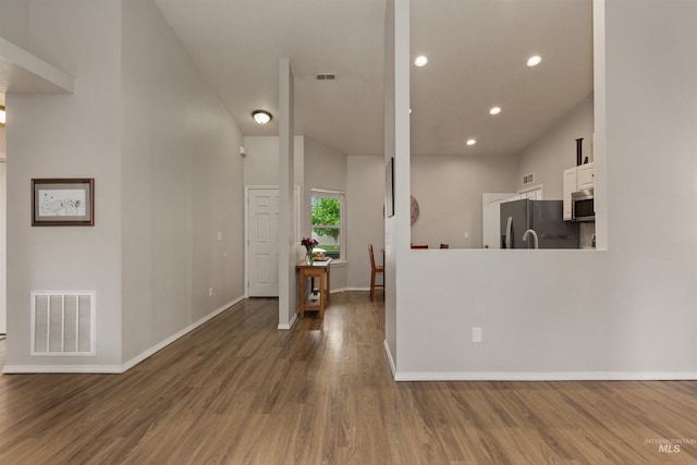 3422 Vistapark Dr, Caldwell, ID 83605 - kitchen featuring stainless steel appliances, white cabinets, wood finished floors, baseboards, and recessed lighting
