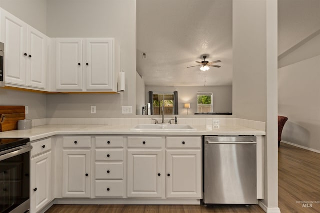 3422 Vistapark Dr, Caldwell, ID 83605 - kitchen featuring stainless steel appliances, a sink, a ceiling fan, white cabinets, and dark wood finished floors