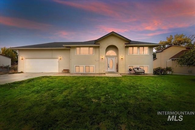 view of front facade with a garage and a lawn