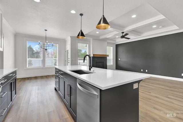 1440 E Azan St, Meridian, ID 83646 - kitchen with baseboards, light countertops, light wood finished floors, dishwasher, and a sink