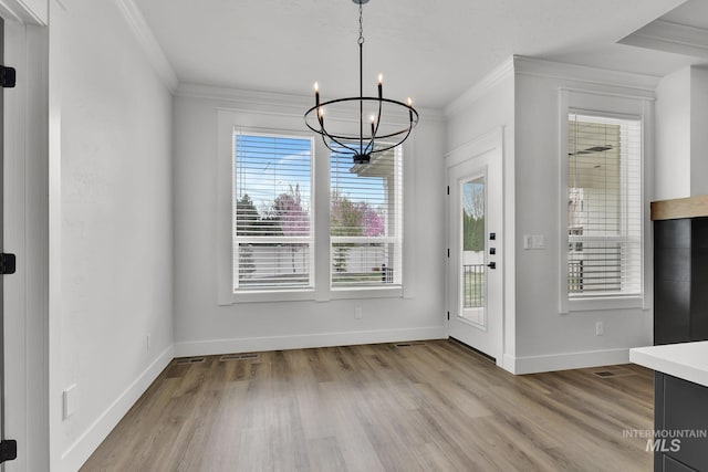 1440 E Azan St, Meridian, ID 83646 - unfurnished dining area with a chandelier, crown molding, and wood finished floors