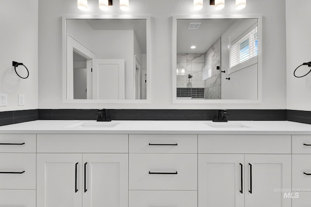 1440 E Azan St, Meridian, ID 83646 - bathroom with a sink, visible vents, a tile shower, and double vanity