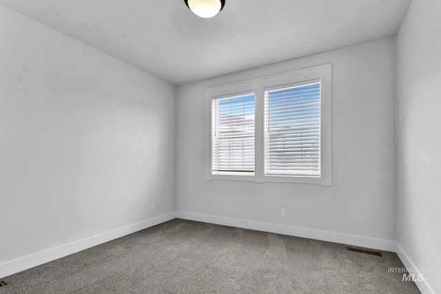 1440 E Azan St, Meridian, ID 83646 - spare room with dark colored carpet, visible vents, and baseboards