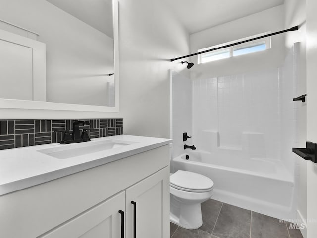 1440 E Azan St, Meridian, ID 83646 - full bathroom with toilet, bathing tub / shower combination, vanity, tile patterned floors, and decorative backsplash