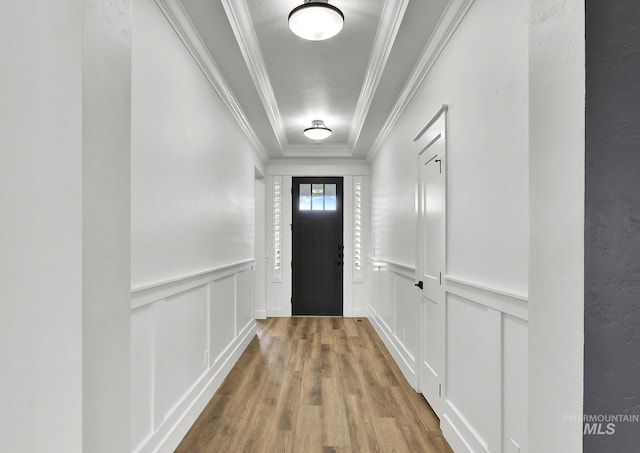 1440 E Azan St, Meridian, ID 83646 - doorway to outside featuring crown molding, wood finished floors, a wainscoted wall, and a decorative wall