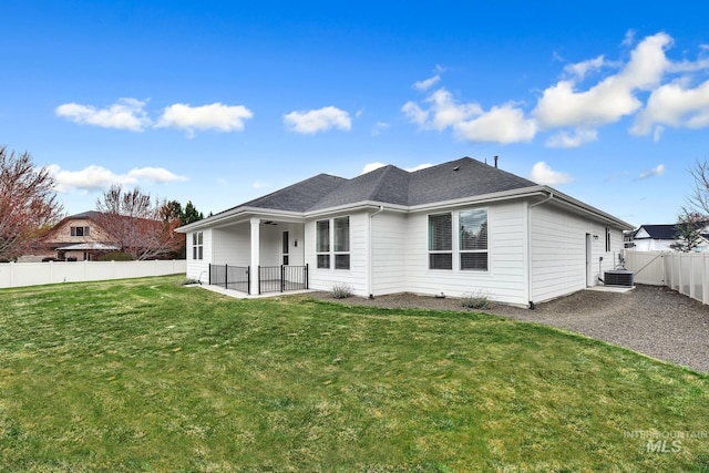 1440 E Azan St, Meridian, ID 83646 - back of house featuring a fenced backyard, a lawn, roof with shingles, a patio area, and central AC unit