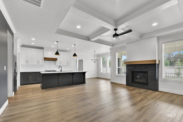 1440 E Azan St, Meridian, ID 83646 - kitchen featuring visible vents, ornamental molding, open floor plan, light wood-type flooring, and ceiling fan with notable chandelier