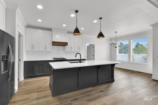 1440 E Azan St, Meridian, ID 83646 - kitchen featuring black fridge, a sink, and ornamental molding