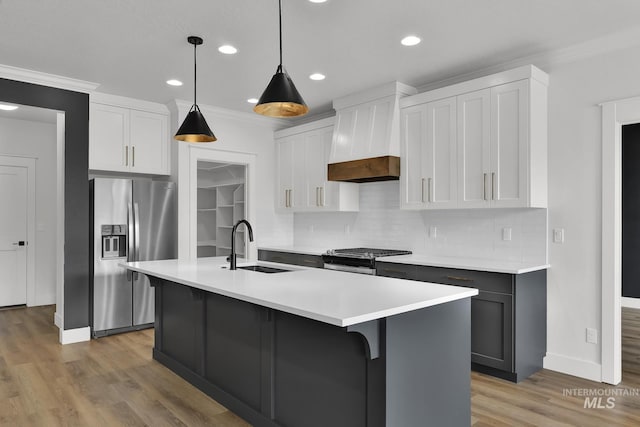 1440 E Azan St, Meridian, ID 83646 - kitchen featuring decorative backsplash, appliances with stainless steel finishes, custom range hood, and a sink