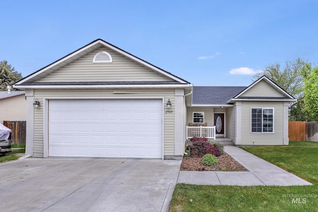 single story home with concrete driveway, a garage, and covered porch