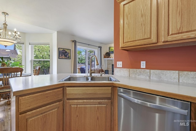 kitchen with dishwasher, a sink, light countertops, a chandelier, and a peninsula