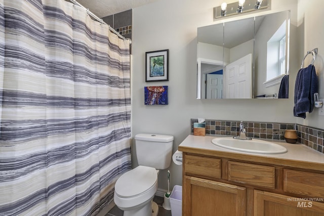 bathroom featuring toilet and vanity