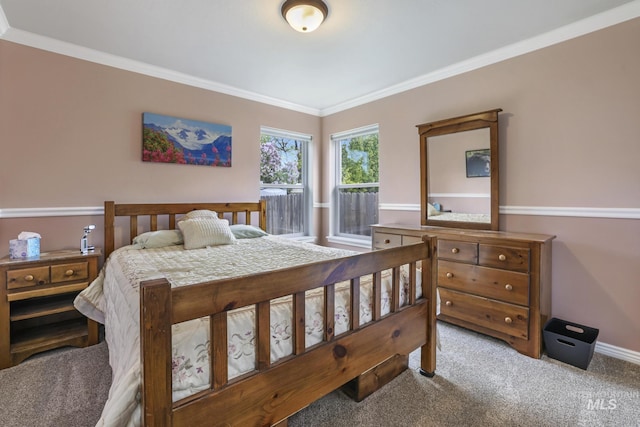 carpeted bedroom featuring ornamental molding and baseboards