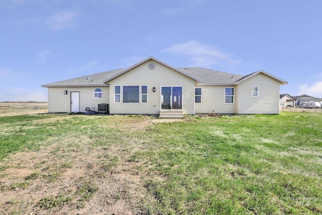 251 Mariposa Cir, Shoshone, ID 83352 - back of property with a lawn, central AC unit, and entry steps