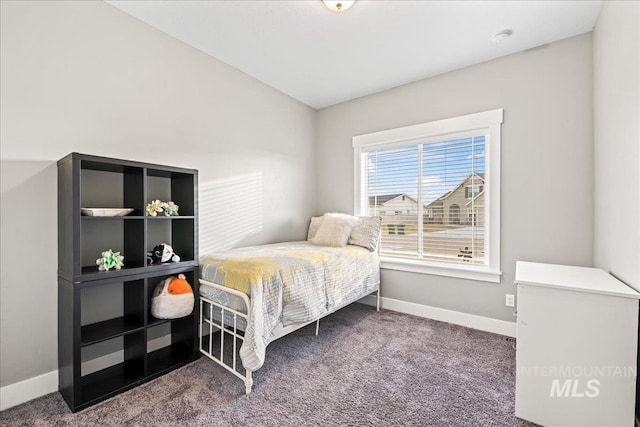 carpeted bedroom featuring baseboards