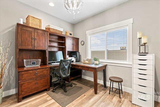 office with baseboards and light wood-style floors