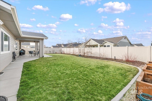 view of yard featuring a residential view, a fenced backyard, and a patio area