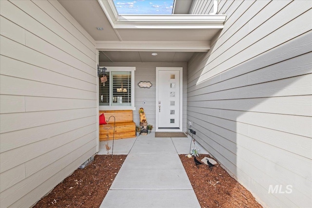 view of exterior entry with a porch