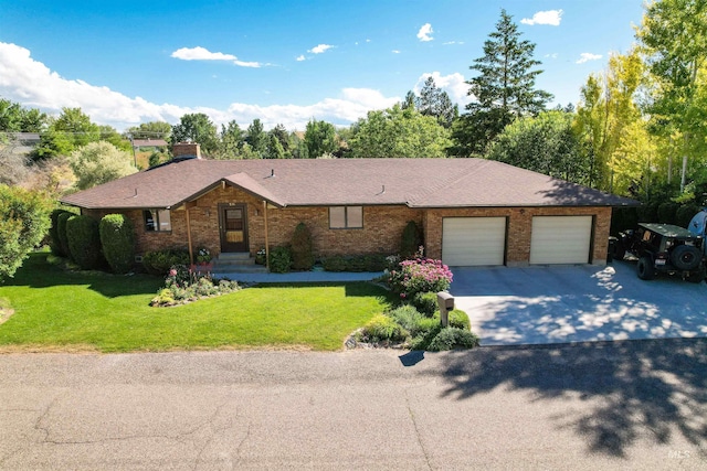 single story home featuring a garage, a front yard, brick siding, and driveway