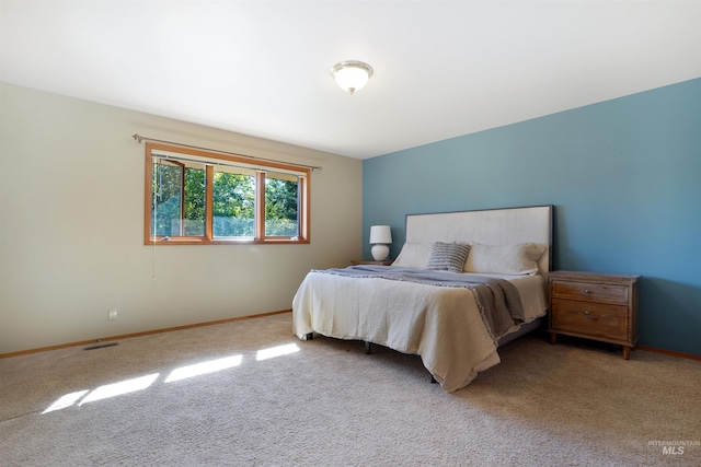 bedroom featuring carpet floors, visible vents, and baseboards