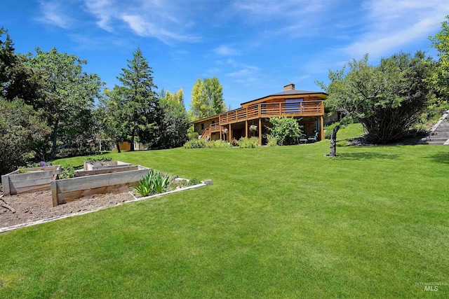 view of yard with a garden and a deck