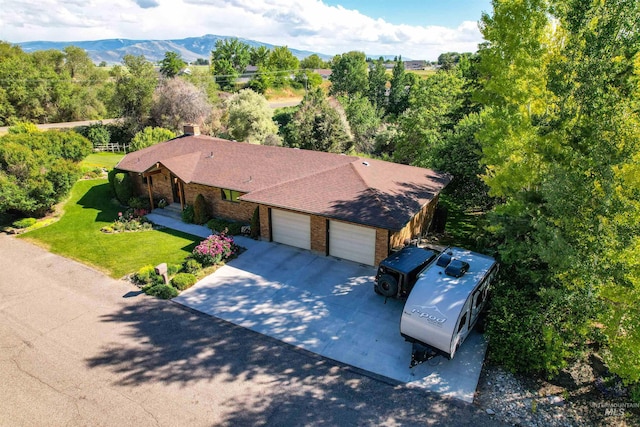 birds eye view of property with a mountain view